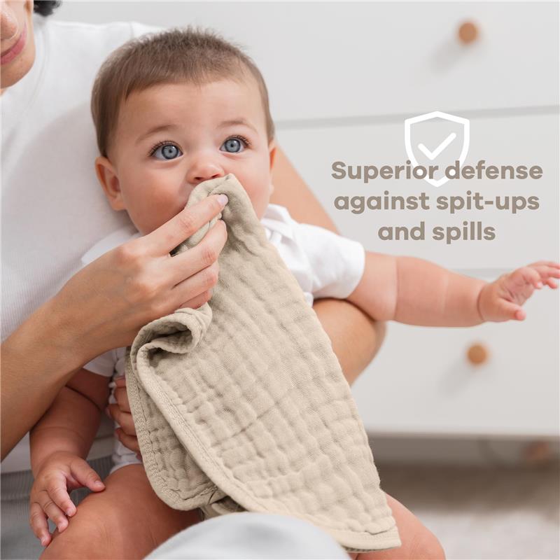 Muslin burp cloth being used by an adult with a baby, highlighting its effectiveness against spills and spit-ups.