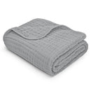Muslin baby blanket in heather blue, folded neatly, showcasing its soft, textured fabric.
