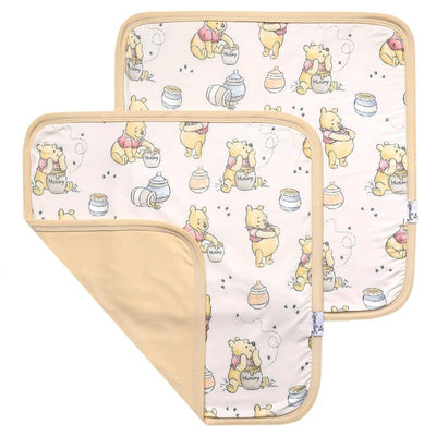 Two 3-layer knit security blankets featuring Winnie the Pooh and honey pots, in soft beige and pastel colors.