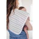 Premium baby burp cloth in a striped design draped over a caregiver’s shoulder, with a baby held close.