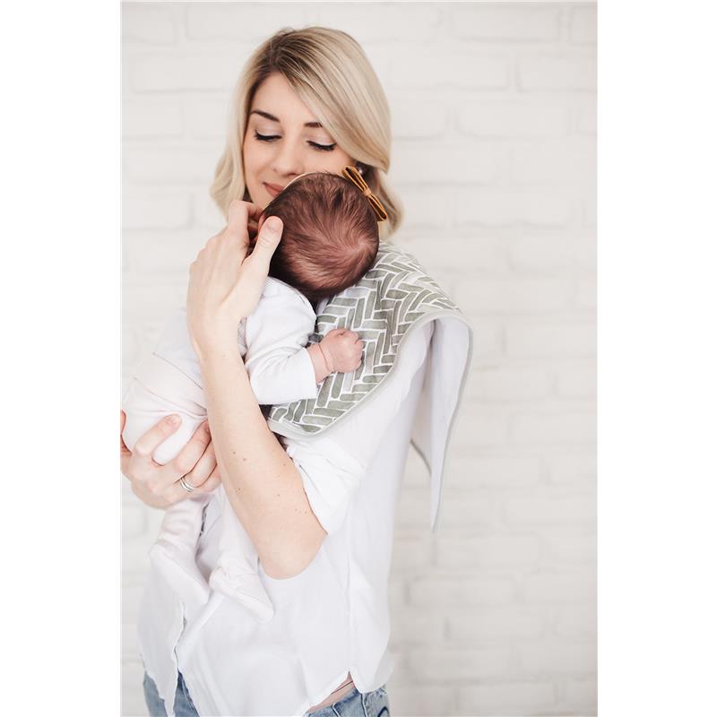 Mother holding a baby over her shoulder, wearing a Copper Pearl burp cloth in a herringbone pattern.