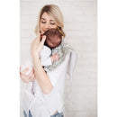 Mother holding a baby over her shoulder, wearing a Copper Pearl burp cloth in a herringbone pattern.
