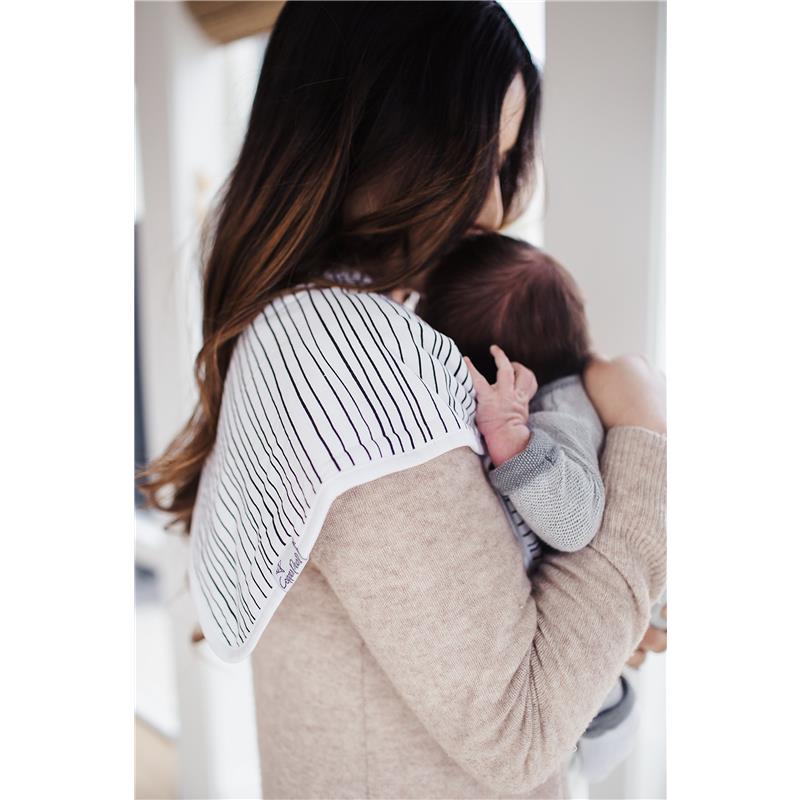 A woman holds an infant while wearing a striped Cotton burp cloth over her shoulder, showcasing the Copper Pearl brand.
