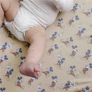 Premium crib sheet featuring a playful Mickey Mouse design, with a baby’s arm and leg visible on the sheet.