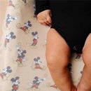 Premium diaper changing pad cover featuring a playful Mickey Mouse pattern, with a baby’s legs and hands visible.