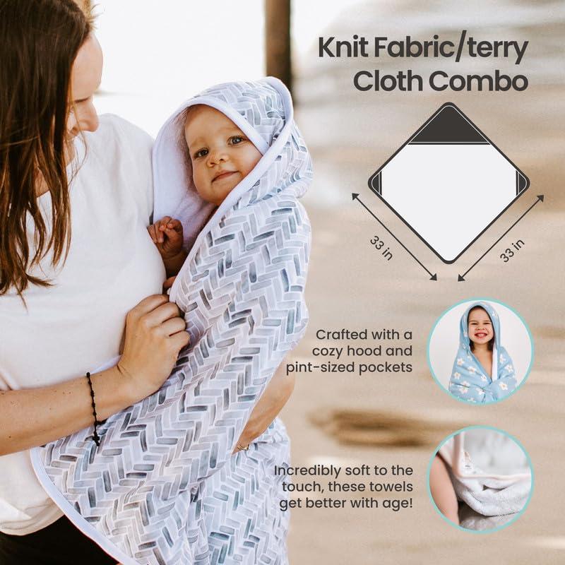 Hooded towel in a soft knit fabric, being held by a woman with a smiling baby inside, featuring cozy design and pint-sized pockets.
