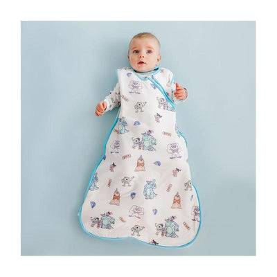 Baby wearing a Copper Pearl Monsters Inc Friends 0.5 Tog Sleep Bag, featuring colorful monster illustrations, on a light blue background.