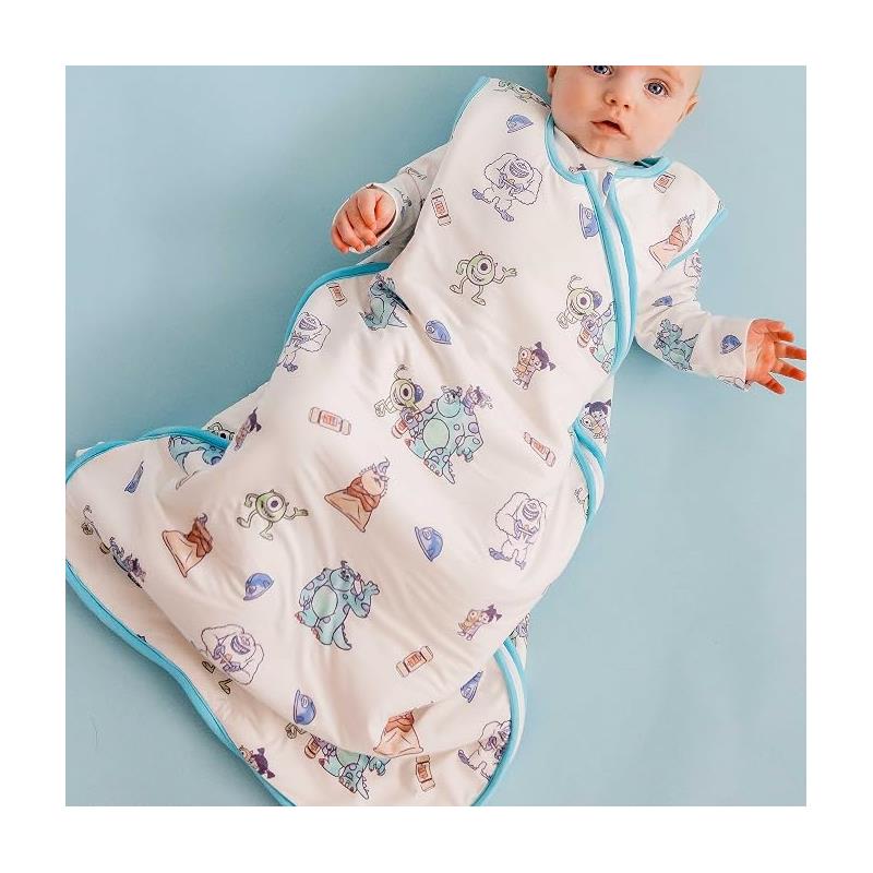 Baby in a Cotton Pearl Monsters Inc Friends sleep bag featuring colorful character illustrations; suitable for 0-6 months.