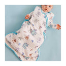 Baby in a Cotton Pearl Monsters Inc Friends sleep bag featuring colorful character illustrations; suitable for 0-6 months.