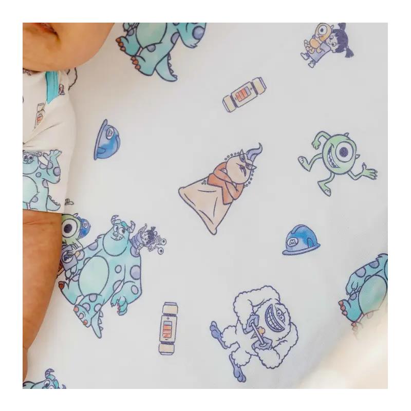 Premium crib sheet featuring colorful Monsters Inc characters, including Mike and Sulley, on a white background.