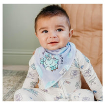 Smiling baby wearing a blue bandana bib featuring Monsters Inc characters, dressed in a patterned onesie.