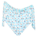 Knit blanket featuring a whimsical Monsters Inc. design in a blue and white diamond pattern.
