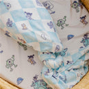 Knit blanket featuring characters from Monsters Inc, with a blue checkered pattern and playful illustrations.