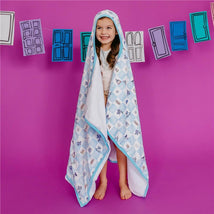 Big kid hooded towel featuring a colorful Monsters Inc. design, worn by a smiling girl against a purple background.