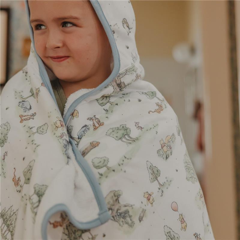 Big kid hooded towel featuring Hundred Acre Wood characters, wrapped around a smiling child with a playful expression.