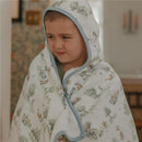 Hooded towel featuring Hundred Acre Wood characters, wrapped around a smiling child with short hair.
