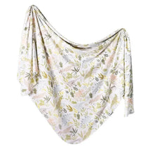 Knit baby swaddle blanket with soft, pastel animal and leaf patterns, designed for comfort and warmth.