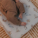 Premium diaper changing pad cover featuring Winnie The Pooh & friends, with a baby resting on it.
