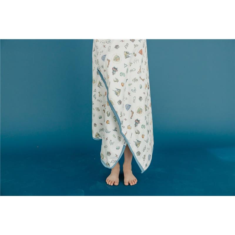 Hooded towel featuring whimsical, colorful designs inspired by the Wizarding World™, draped on a child standing barefoot.