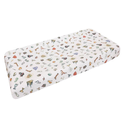 Premium diaper changing pad cover featuring a variety of whimsical, Wizarding World-themed illustrations.