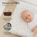 Premium knit diaper changing pad cover featuring a soft, speckled design with a newborn baby lying on it.