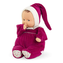 Corolle Dolls Babipouce in pink grenadine, featuring a soft body, floral-patterned feet, and a pointed hat.