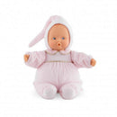 Soft-bodied baby doll dressed in a pink outfit with a bunny hood, featuring blue eyes and a round face.
