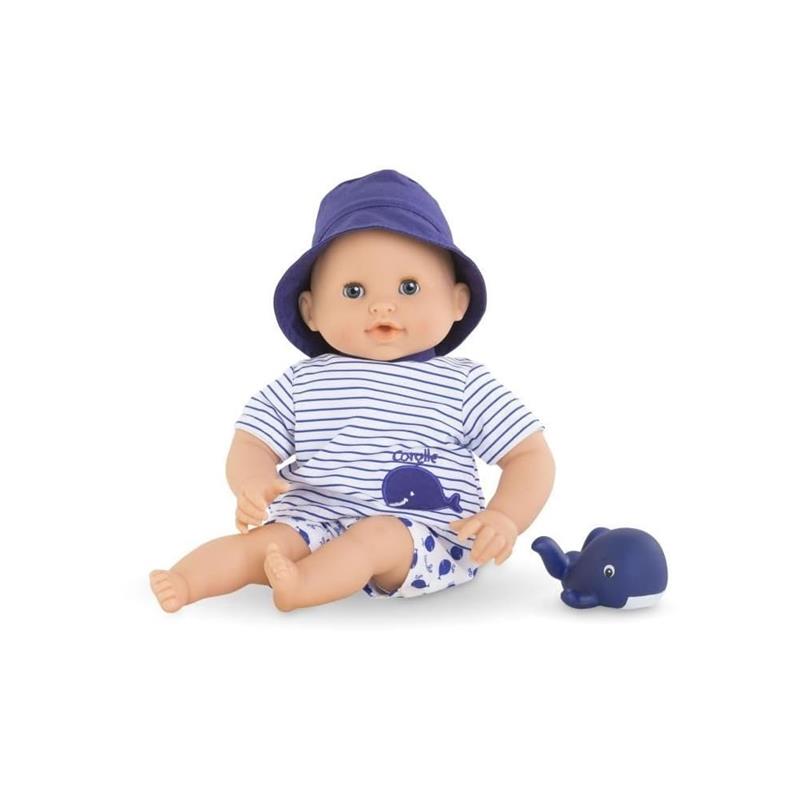 Corolle Bebe Bath Marin baby doll wearing a striped shirt and hat, with a rubber whale toy beside it.
