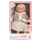 Bébé Calin Margaux doll in a white dress with gold polka dots and a furry vest, packaged in pink box, limited edition.