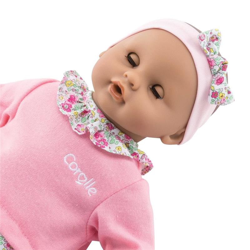 12-inch Corolle Baby Doll with a pink outfit, floral collar, and matching headband, designed for imaginative play.