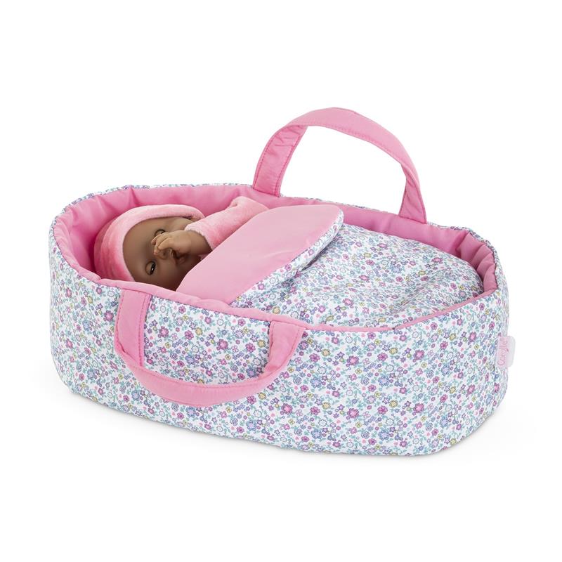 Floral Moses basket accessory with pink trim, holding a 30 cm doll wrapped in a soft pink blanket.