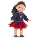 Corolle Ma Perle doll dressed in a navy sweater with a plaid collar and a red tulle skirt, standing upright.