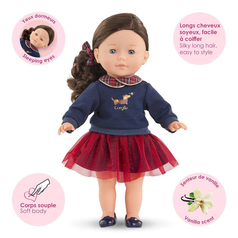 Corolle Dolls Ma Perle wearing a navy sweater, plaid collar, and red tulle skirt, featuring sleeping eyes and vanilla scent.