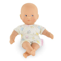 Corolle Dolls Mini Calin Bunnies doll with blue eyes, wearing a short-sleeve outfit featuring colorful bunny designs.