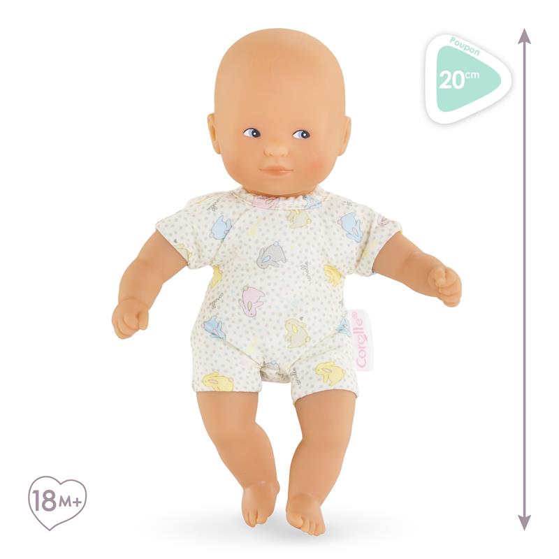 Mini Calin Bunnies doll by Corolle, featuring blue eyes, wearing a bunny-patterned outfit, suitable for ages 18 months and up.