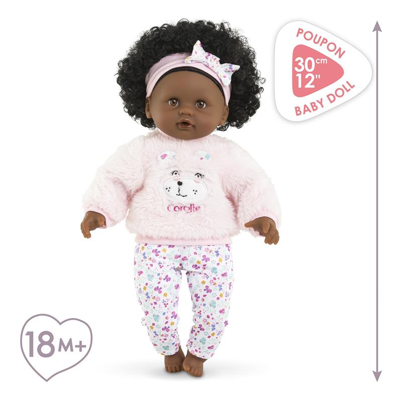 Baby Calin Caroline doll by Corolle dressed in a pink fuzzy sweater with a bear face and floral pants, suitable for ages 18 months and up.