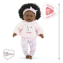 Baby Calin Caroline doll by Corolle dressed in a pink fuzzy sweater with a bear face and floral pants, suitable for ages 18 months and up.