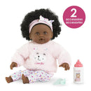 My First Doll, Baby Calin Caroline is a 12-inch doll with curly hair, wearing a pink bear sweater and floral leggings, accompanied by a bottle.