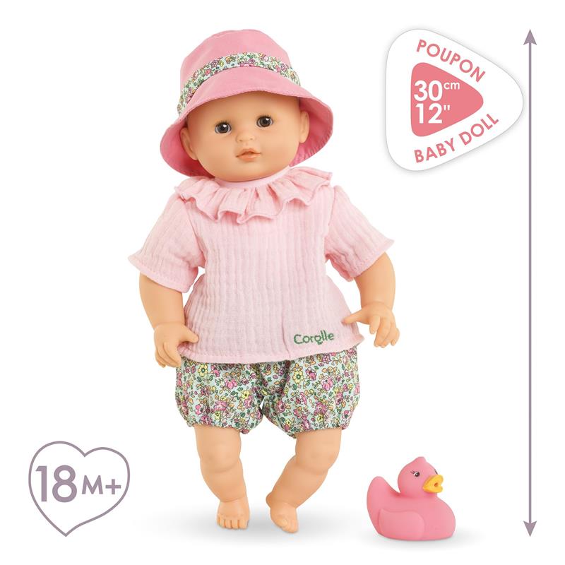 Corolle Dolls Premier Poupon Coralie Baby Doll dressed in a pink outfit, with a pink hat and a rubber duck accessory.