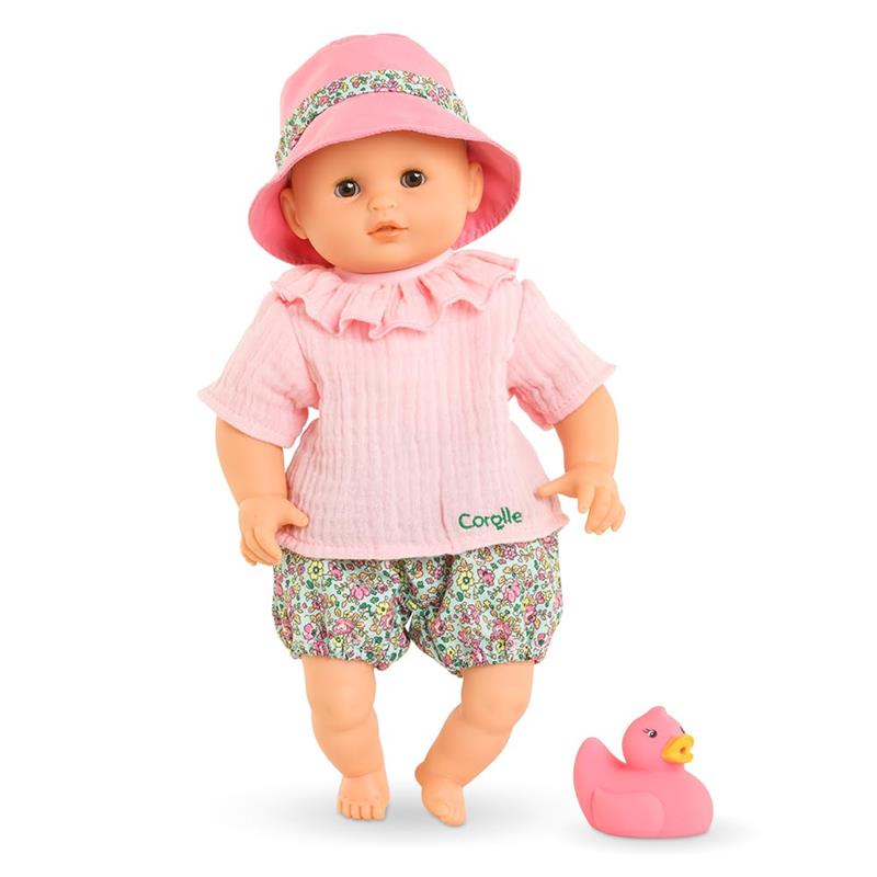 Corolle Premier Poupon Coralie Baby Doll in a pink outfit with floral shorts and a matching hat, accompanied by a pink rubber duck.