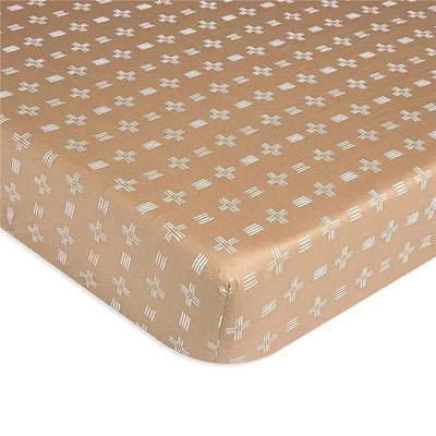 Soft cotton crib mattress sheet in copper with a geometric dash pattern, designed for babies.