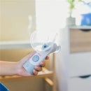 Cordless Crane warm and cool mist inhaler held in hand, featuring a transparent mist chamber and control button.
