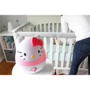 Hello Kitty-themed ultrasonic humidifier on a table, with a person adjusting it near a crib.