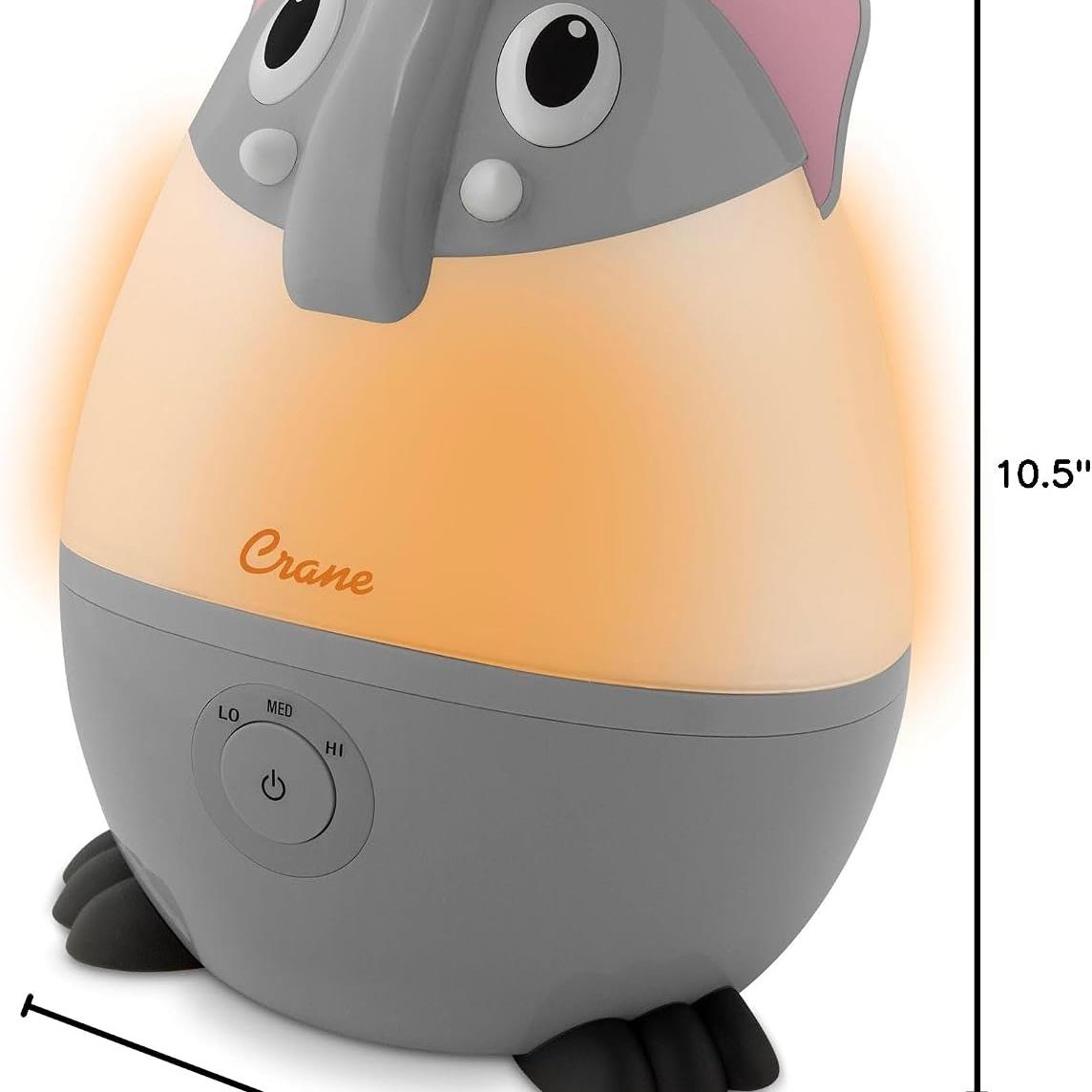 Ultrasonic cool mist humidifier in the shape of a gray elephant, featuring a warm light, control button, and measuring 10.5 inches tall.