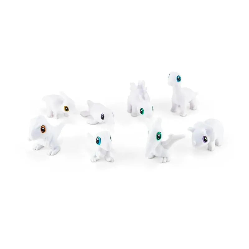 Scribble Scrubbie dinosaur figures in white, featuring various playful designs and colorful eyes, ready for coloring fun.