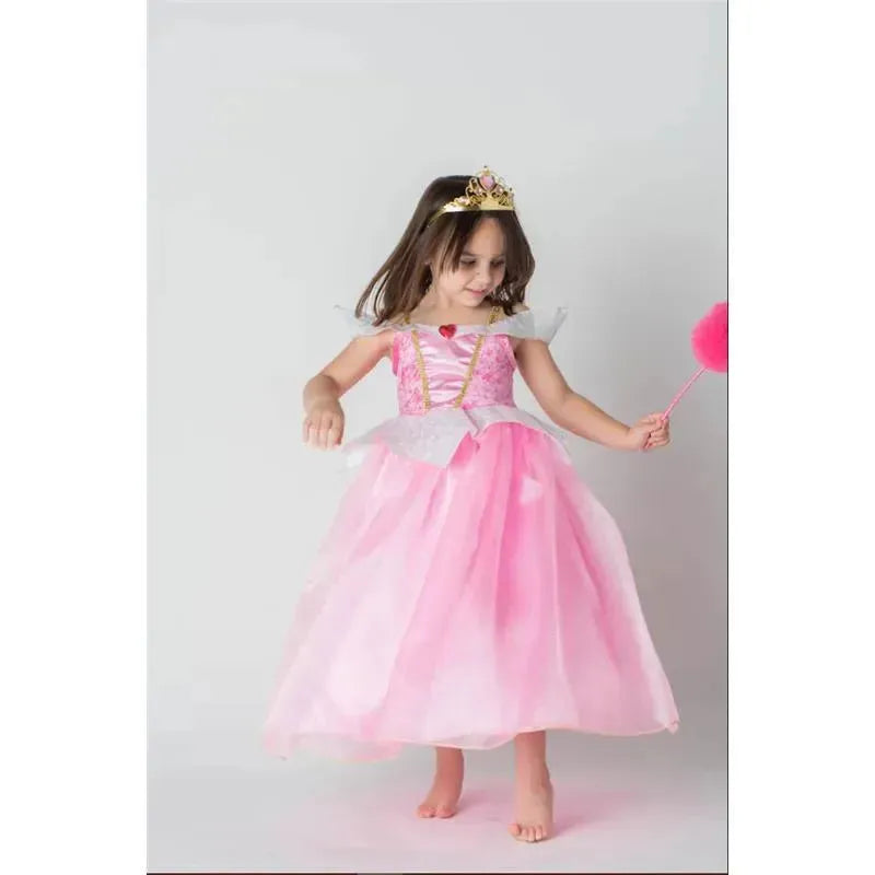 Young girl in a pink Disney princess dress with a crown and wand, joyfully twirling against a light background.