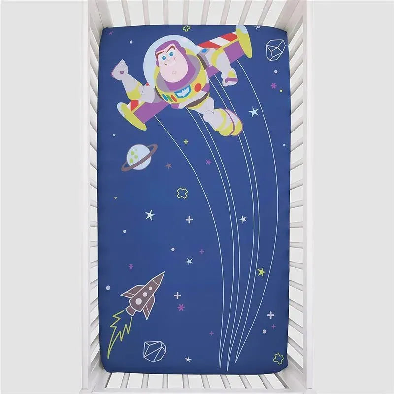 Crown Crafts Disney Buzz Lightyear crib fitted sheet featuring Buzz Lightyear flying in space with planets and stars.