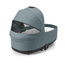 Cybex Balios Cot S Lux in Stone Grey, featuring a sleek design with a mesh window and soft interior padding.