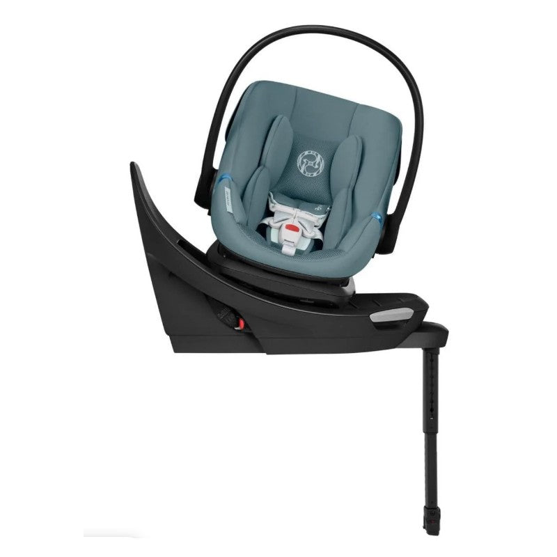 Cybex Aton G2 infant car seat in stormy blue, mounted on a base with adjustable leg support and a safety harness.