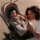 Cybex Balios S Lux stroller in Moon Black with a happy mother interacting with her baby, both stylishly dressed.
